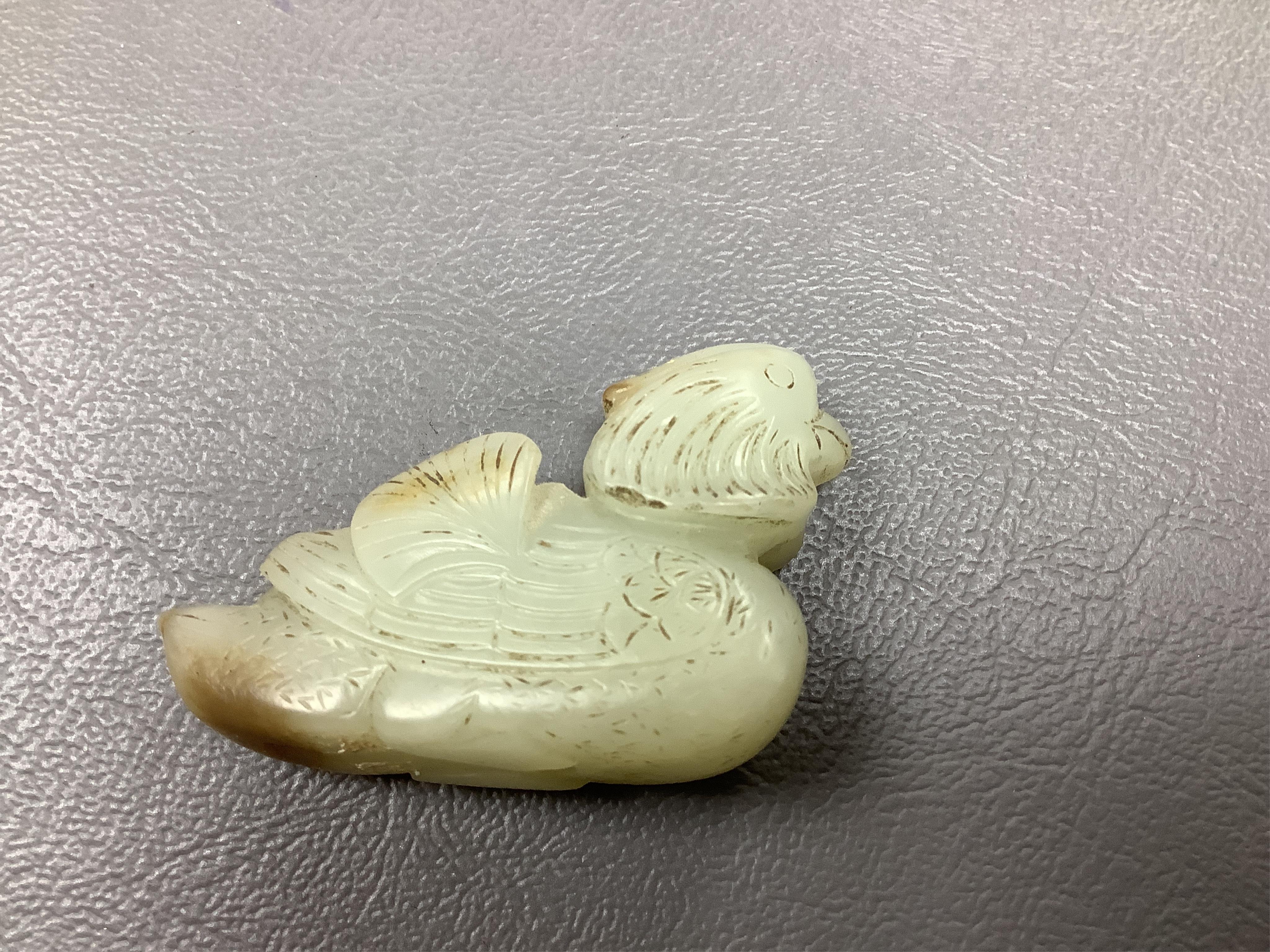 A Chinese jade figure of a Mandarin duck and a miniature pot and cover, three jadeite carvings and a bowenite dragon, 16.5cm